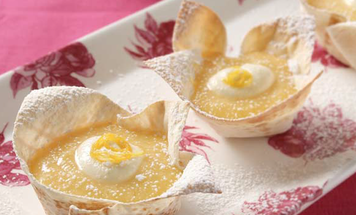 Mountain-Bread-orange-and-lemon-curd-tarts-in-mountain-bread-base-served-with-a-dollop-of-cream-and-dusted-with-icing-sugar.